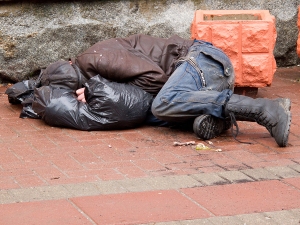 bigstock-Homeless-man-sleeps-on-a-pavem-32824019